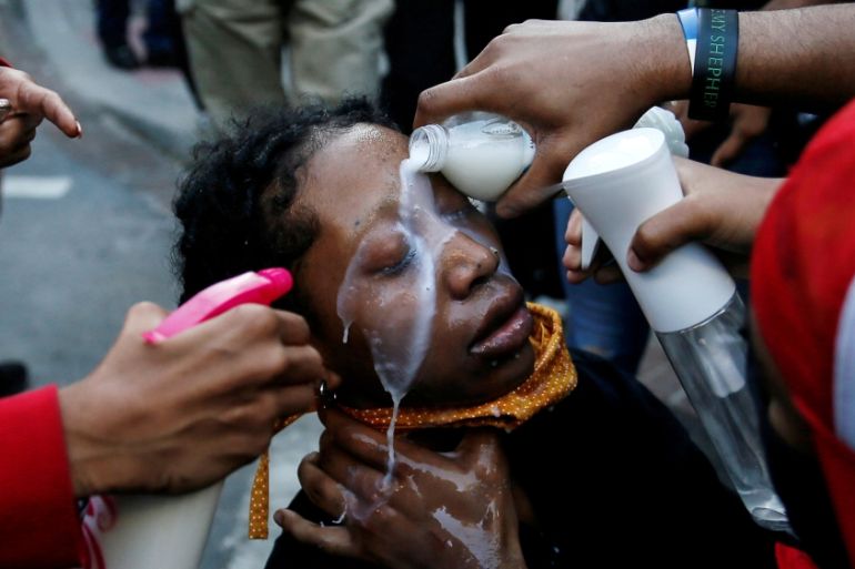 A woman affected by pepper spray is attended to by others during a protest amid nationwide unrest following the death in Minneapolis police custody of George Floyd, at Lafayette Park near the White Ho
