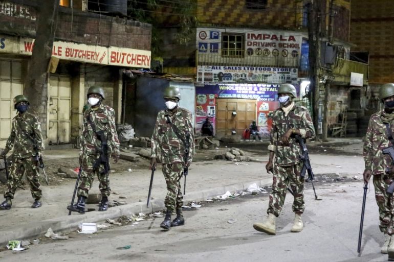Kenyan police patrol at night after the start of the daily dusk-to-dawn curfew in the Eastleigh area of Nairobi, Kenya Wednesday, May 6, 2020. The Kenyan government on Wednesday sealed off the Eastlei