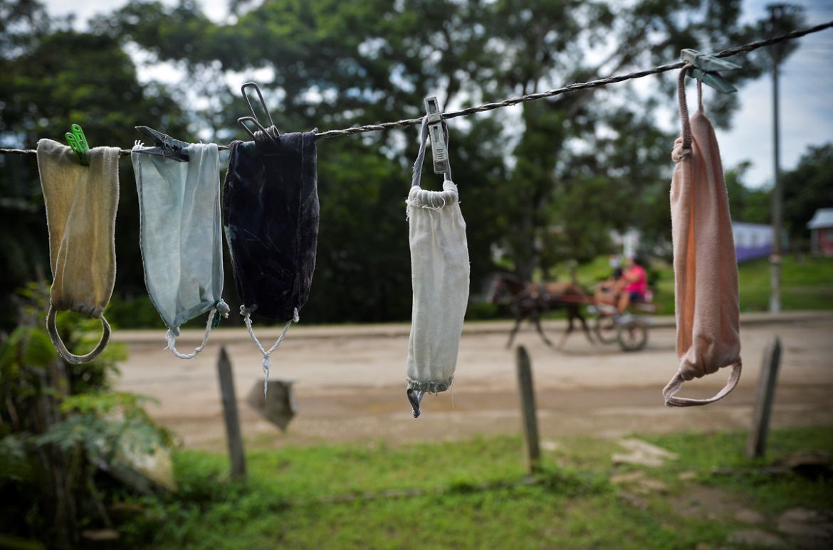 Face masks hang from a rope to dry at a peasants'' house in Bahia Honda, Artemisa province, Cuba on June 22, 2020, amid the new coronavirus pandemic. - Cuba has controlled the pandemic, but its economi
