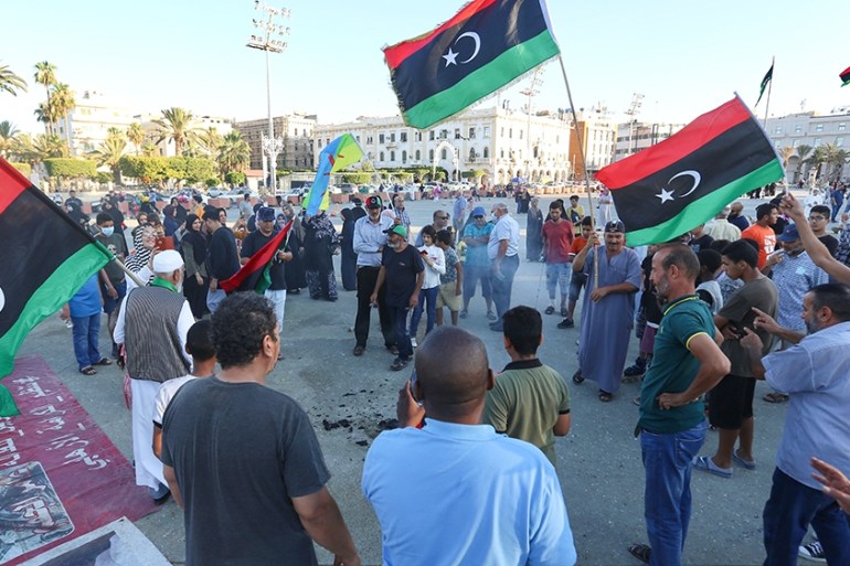 TRIPOLI, LIBYA - JUNE 21: People carry flags of Libya during a protest against President of Egypt Abdel-Fattah Al-Sisi following his intervention threat at Martyrs Square in Tripoli, Libya on June 21,