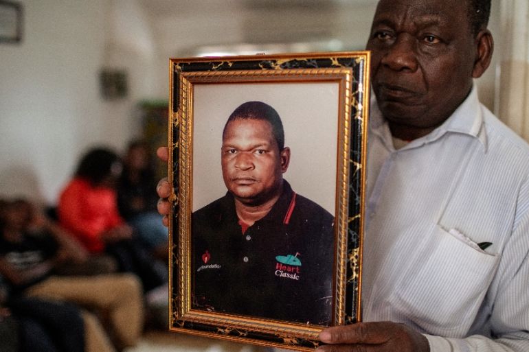 FILES) In this file photo taken on October 11, 2019 Filipe Mahajane, spokesperson for the Matavele family, holds a portrait of murdered Executive Director of the Non Governmental Organisation