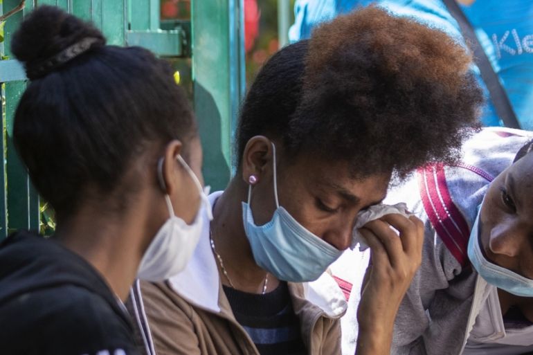 An Ethiopian domestic worker cries as she waits with dozens of others outside the Ethiopian consulate, some inquiring about flights home, others stranded after they were abandoned by employers who cla