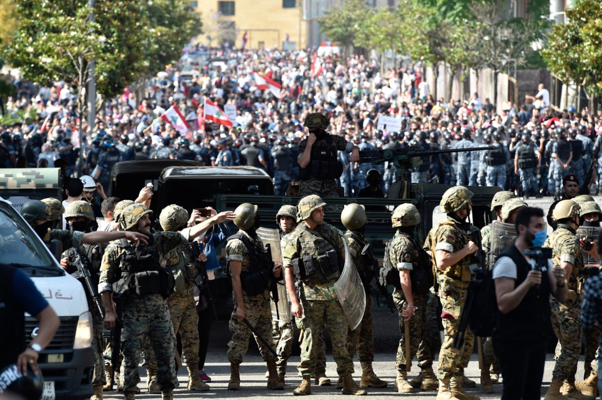 epa08469789 Security forces including Lebanese Army units block a protesters'' march during a mass demonstration against the Lebanese government and worsening economic conditions, a road near the Moham