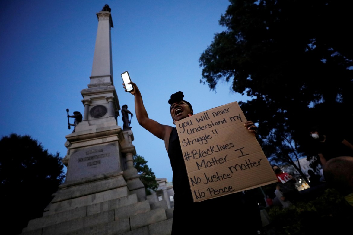 A protester speaks to the crowd underneath a Confederate monument during nationwide unrest following the death in Minneapolis police custody of George Floyd, in Raleigh, North Carolina, U.S. May 31, 2
