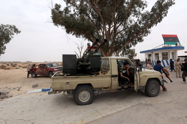 Fighters loyal to Libya''s internationally recognised government are seen after taking control of Watiya airbase near Tripoli