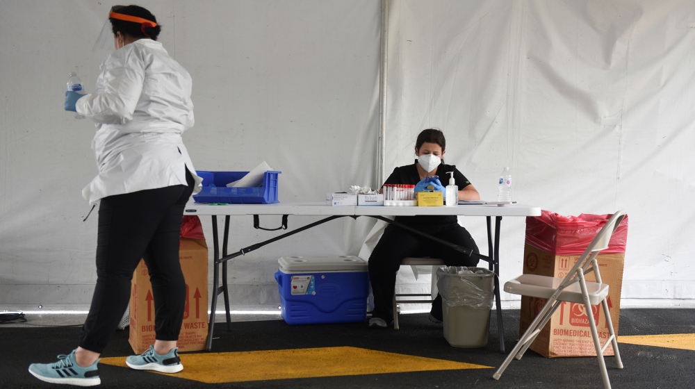 Medical workers coordinate testing as dozens of people wait in their cars at United Memorial Medical Center amid the global outbreak of the coronavirus disease (COVID-19), in Houston, Texas, U.S., Jun