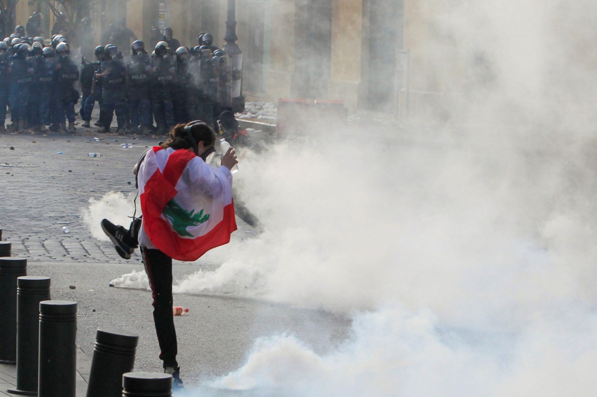 A demonstrator kicks back a tear gas canister during a protest against the government performance and worsening economic conditions, in Beirut, Lebanon June 6, 2020. REUTERS/Aziz Taher