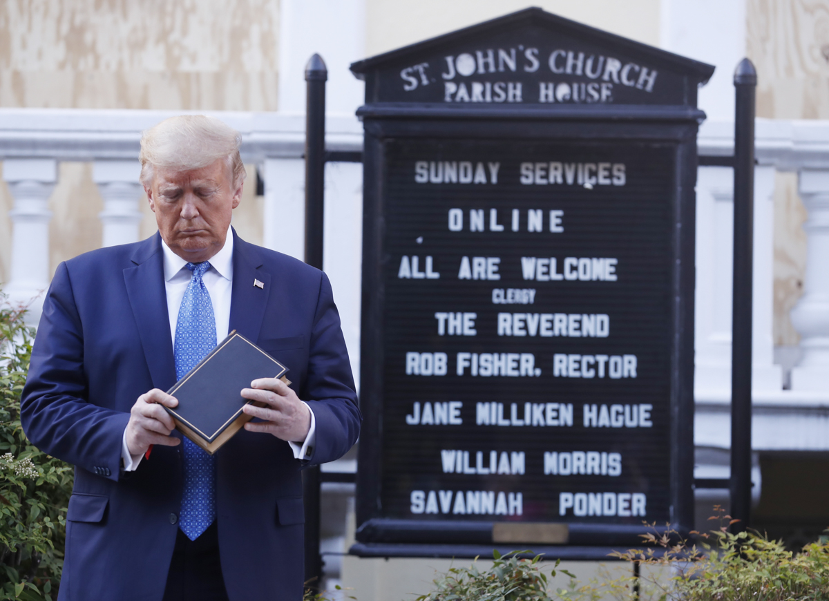 epa08459183 US President Donald J. Trump poses with a bible outside St. John's Episcopal Church after delivering remarks in the Rose Garden at the White House in Washington, DC, USA, 01 June 2020. Tru