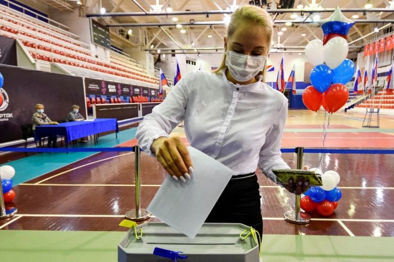 A woman casts her ballot at a polling station during a seven-day vote for constitutional reforms in Vladivostok