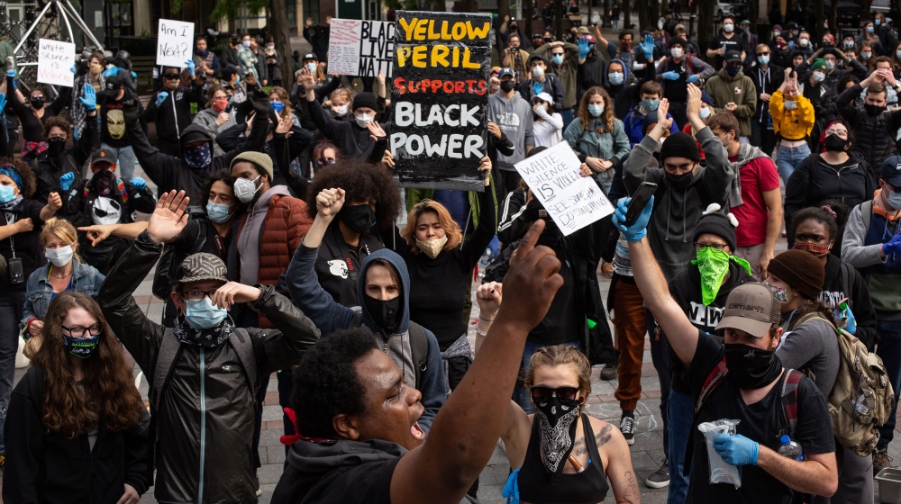 Demonstrators chant during a gathering to protest the recent death of George Floyd on May 31, 2020 in Seattle, Washington. Protests due to the recent death of George Floyd took place in Seattle and it