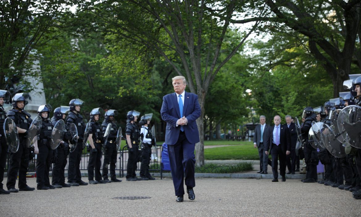 U.S. President Donald Trump walks between lines of riot police in Lafayette Park across from the White House after walking to St John''s Church for a photo opportunity during ongoing protests over rac