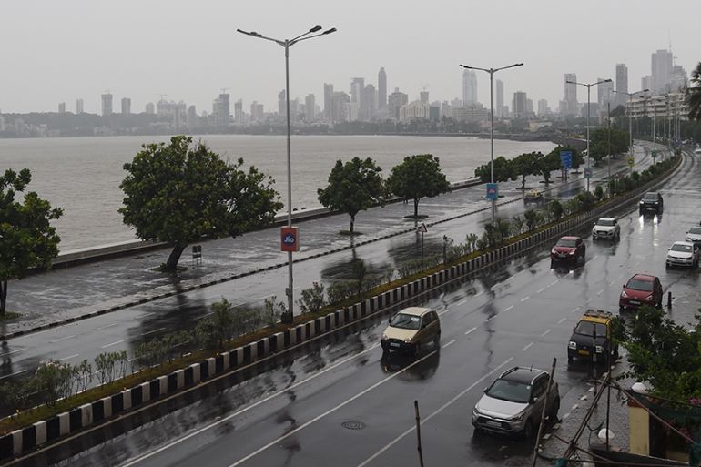 Commuters drive along Marine Drive as rain falls in Mumbai on June 3, 2020 as cyclone Nisarga barrels towards India''s western coast. - Mumbai authorities shut offices, banned small gatherings and told