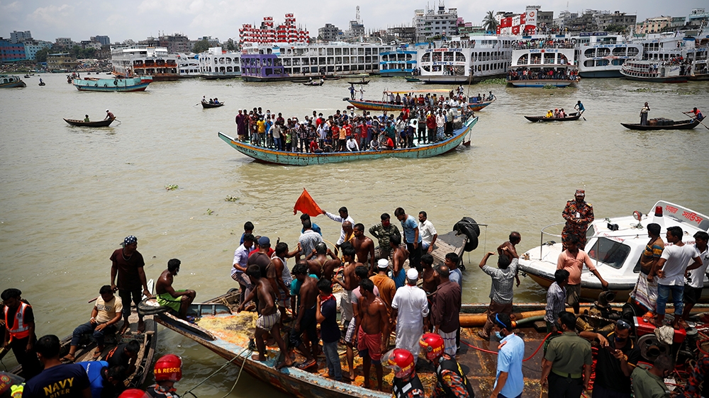 People on a boat watch the spot where a passenger ferry capsized in the river Buriganga in Dhaka, Bangladesh, June 29, 2020. REUTERS/Mohammad Ponir Hossain