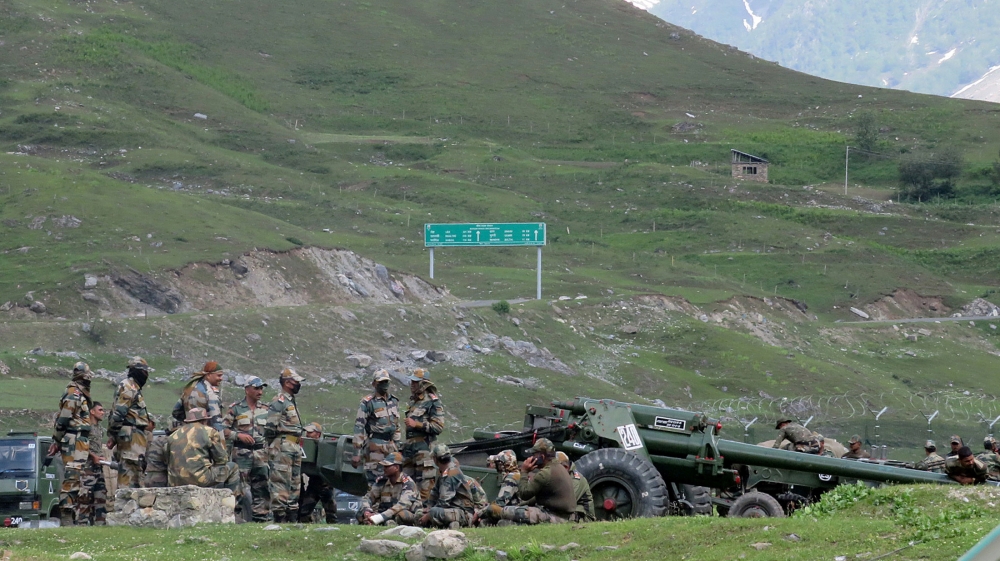 Indian army soldiers rest next to artillery guns at a makeshift transit camp before heading to Ladakh, near Baltal, southeast of Srinagar, June 16, 2020. REUTERS/Stringer NO RESALES. NO ARCHIVES.