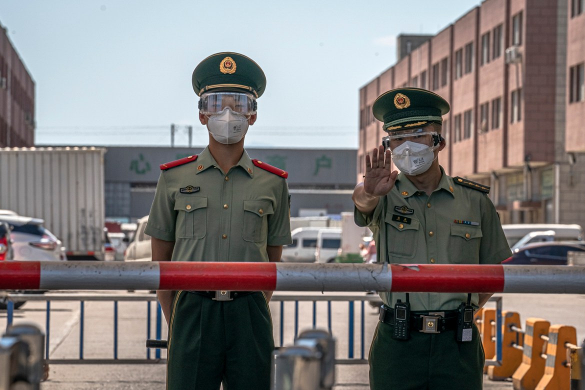 epa08484447 Paramilitary police officers wearing protective face masks stand guard next to the closed Xinfadi market, in Fengtai district, Beijing, China, 14 June 2020. One of Beijing''s largest market