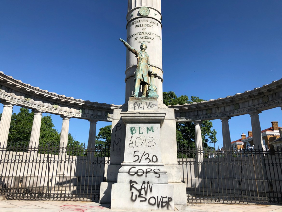 A monument to Confederate President Jefferson Davis in Richmond, Va., is covered with graffiti on Sunday, May 31, 2020, after overnight protests over the death of George Floyd. Many of the city’s most