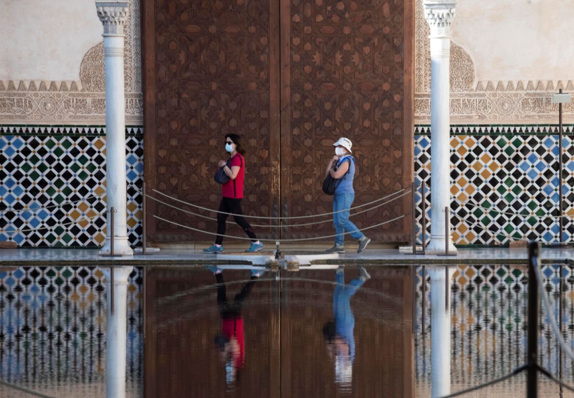 epa08490308 The first visitors walk at Alhambra Palace that has reopened in Granada, Spain, 17 June 2020, with a 50 percent of its capacity and 4,250 tickets per day. The visit has some itinerary mod