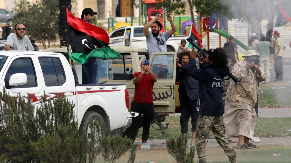 Fighters loyal to Libya's internationally recognised government celebrate after regaining control over Tarhouna city