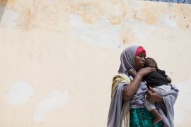 Farhiya and her eight-month-old son await return assistance to Ethiopia at a reception centre in Bosasso, Puntland. She arrived in the country five months ago to look for her husband who left without