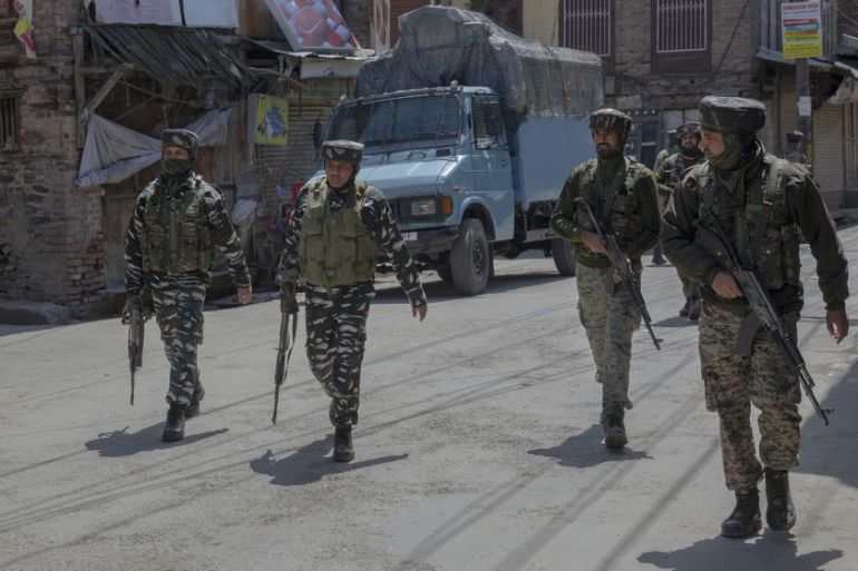 Indian paramilitary soldiers walk back towards their vehicles after a gun battle with suspected rebels ended in Srinagar, Indian controlled Kashmir, Tuesday, May 19, 2020. Indian government forces kil