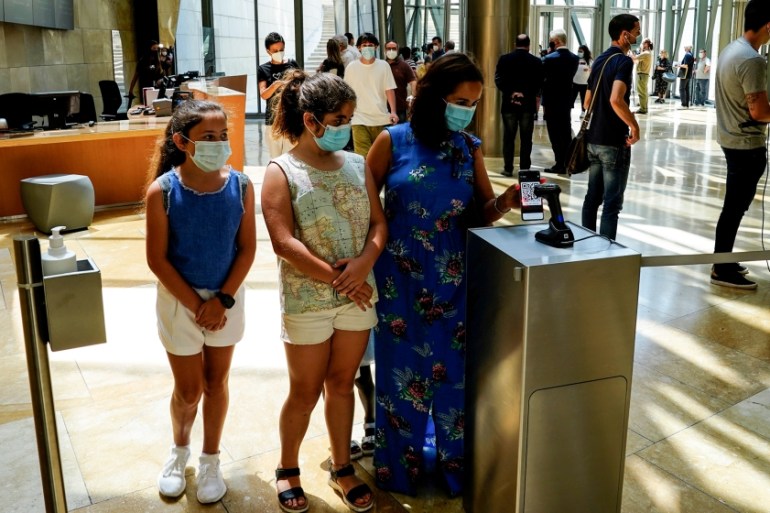 Visitors use an app to enter the Guggenheim Museum on the day it reopens its doors following a three-month closure, amid the coronavirus disease (COVID-19) outbreak, in Bilbao, Spain, June 1, 2020. RE