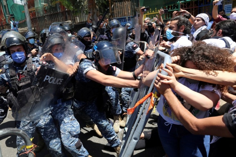 Protesters confront with riot police in Beirut