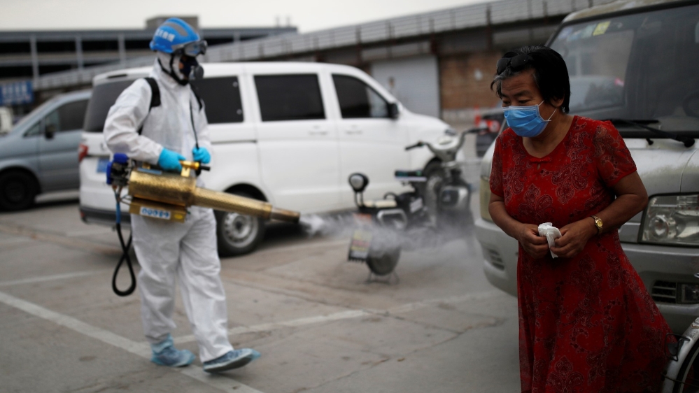 Volunteer from the Blue Sky Rescue team disinfects the Nangong comprehensive market in Beijing