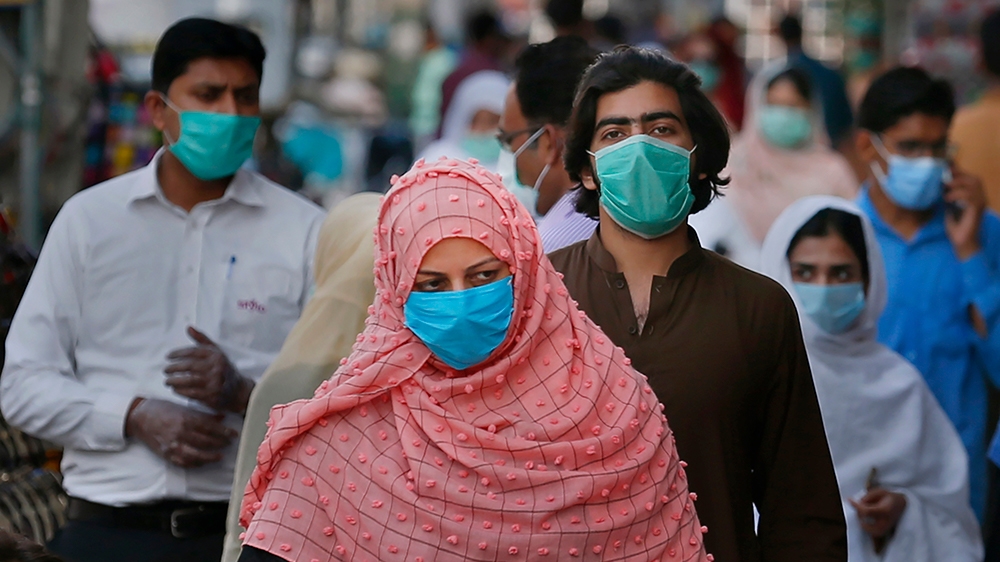 People wearing masks to help curb the spread of the coronavirus shop in a market in Rawalpindi, Pakistan, Tuesday, June 2, 2020. (AP Photo/Anjum Naveed)