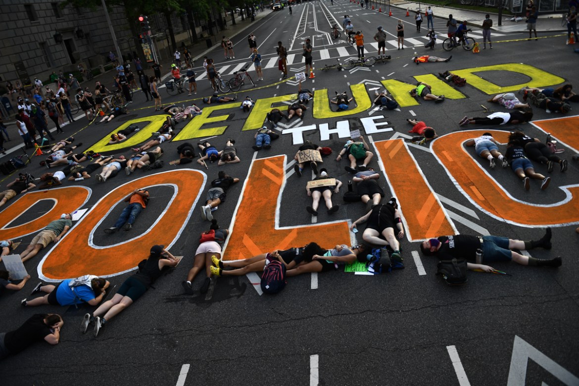 Demonstrators lie on the pavement during a peaceful protest against police brutality and racism, on June 6, 2020 in Washington, DC. - Demonstrations are being held across the US following the death of