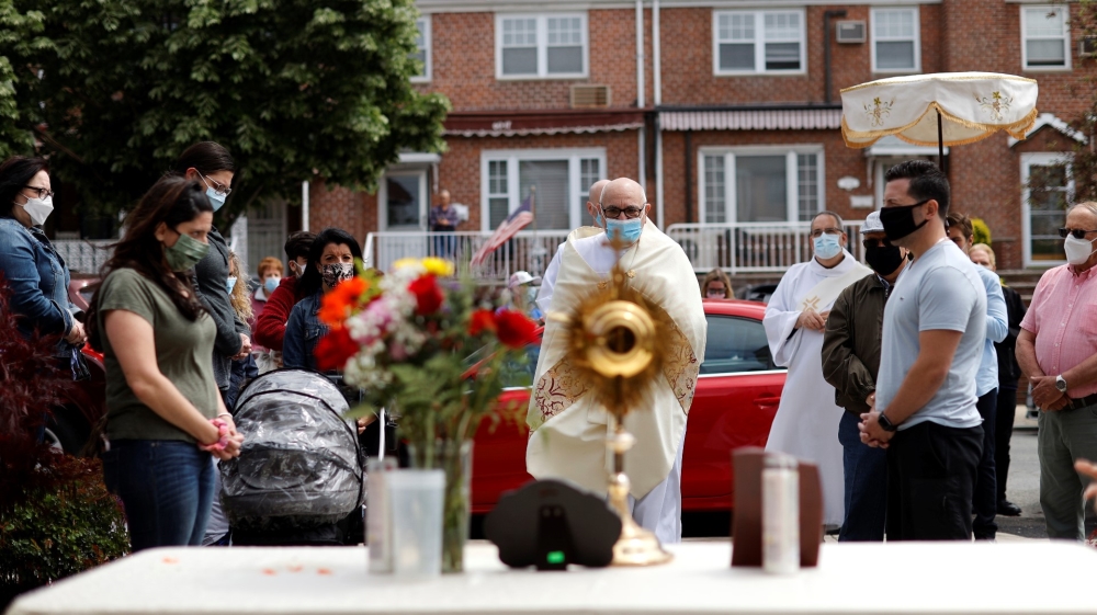 Priests lead Blessed Sacrement procession through Queens neighborhood during outbreak of the coronavirus disease (COVID-19) in New York