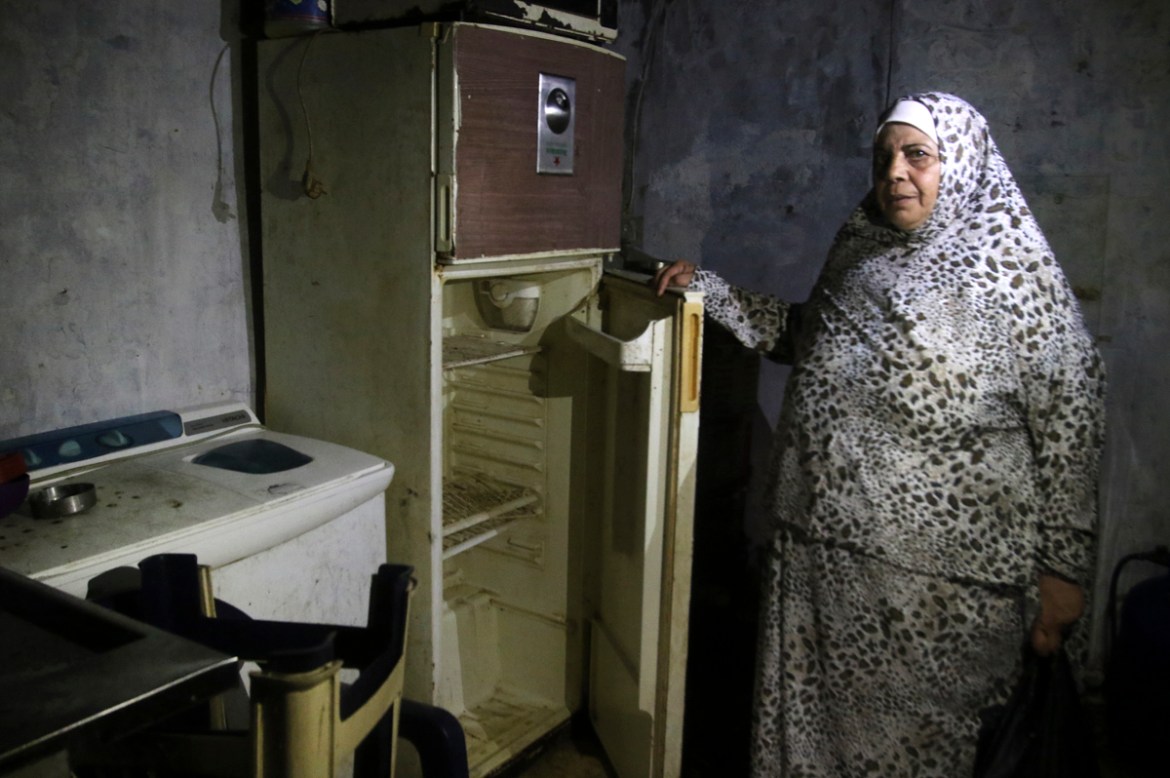 A Lebanese woman displays the content of her refrigerator at her apartment in the southern city of Sidon on June 16, 2020. - Lebanon''s economic crisis has led to a collapse of the local currency and p