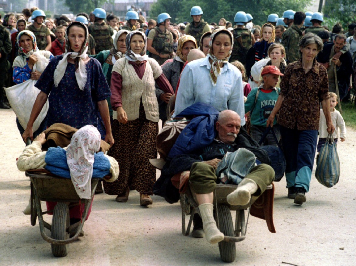 Group of Bosnian Moslems, refugees from Srebrenica, walk to be transported from eastern Bosnian village of Potocari to Moslem held Kladanj near Olovo July 13, 1995. On July 11, 1995, towards the end o