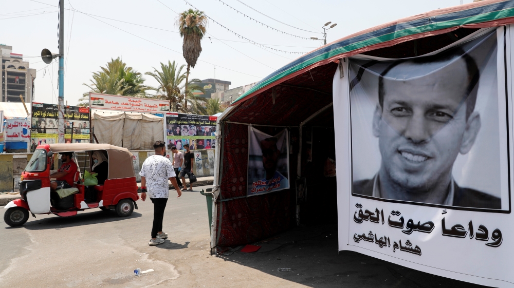 A poster depicting the former government advisor and political analyst Hisham al-Hashemi, who was killed by gunmen is seen at the Tahrir Square in Baghdad