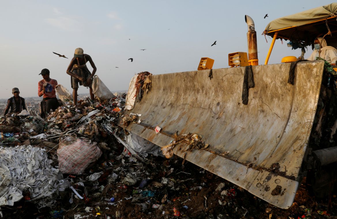 Waste collectors look for recyclable materials at a landfill site, during the coronavirus disease (COVID-19) outbreak, in New Delhi, India, July 9, 2020. REUTERS/Adnan Abidi SEARCH "COVID-19 MEDIC