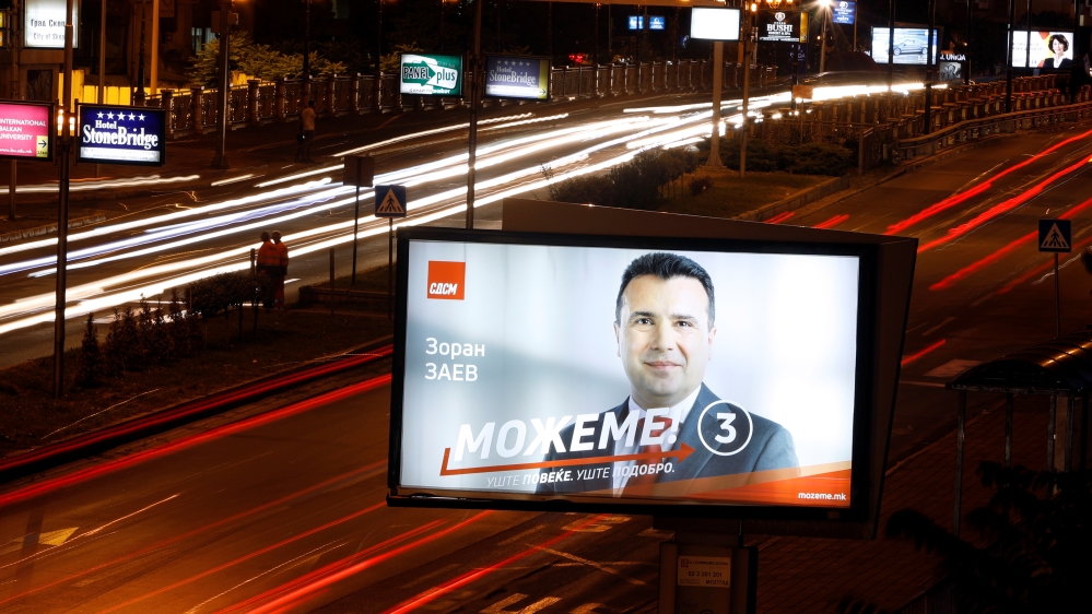 Cars pass next to an electoral billboard of Zoran Zaev in Skopje