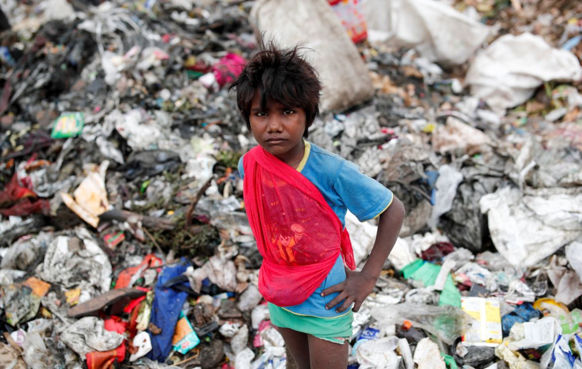 A young waste collector, waits for a truck to offload rubbish onto a landfill site, during the coronavirus disease (COVID-19) outbreak, in New Delhi, India, July 16, 2020. REUTERS/Adnan Abidi SEAR