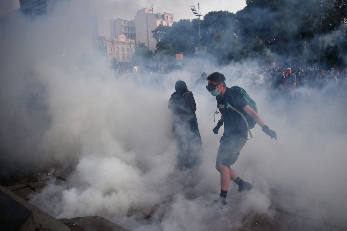 Protesters are surrounded by tear gas as they clash with riot police outside Serbia''s National Assembly building in Belgrade on July 8, 2020, during a demonstration against a weekend curfew announced