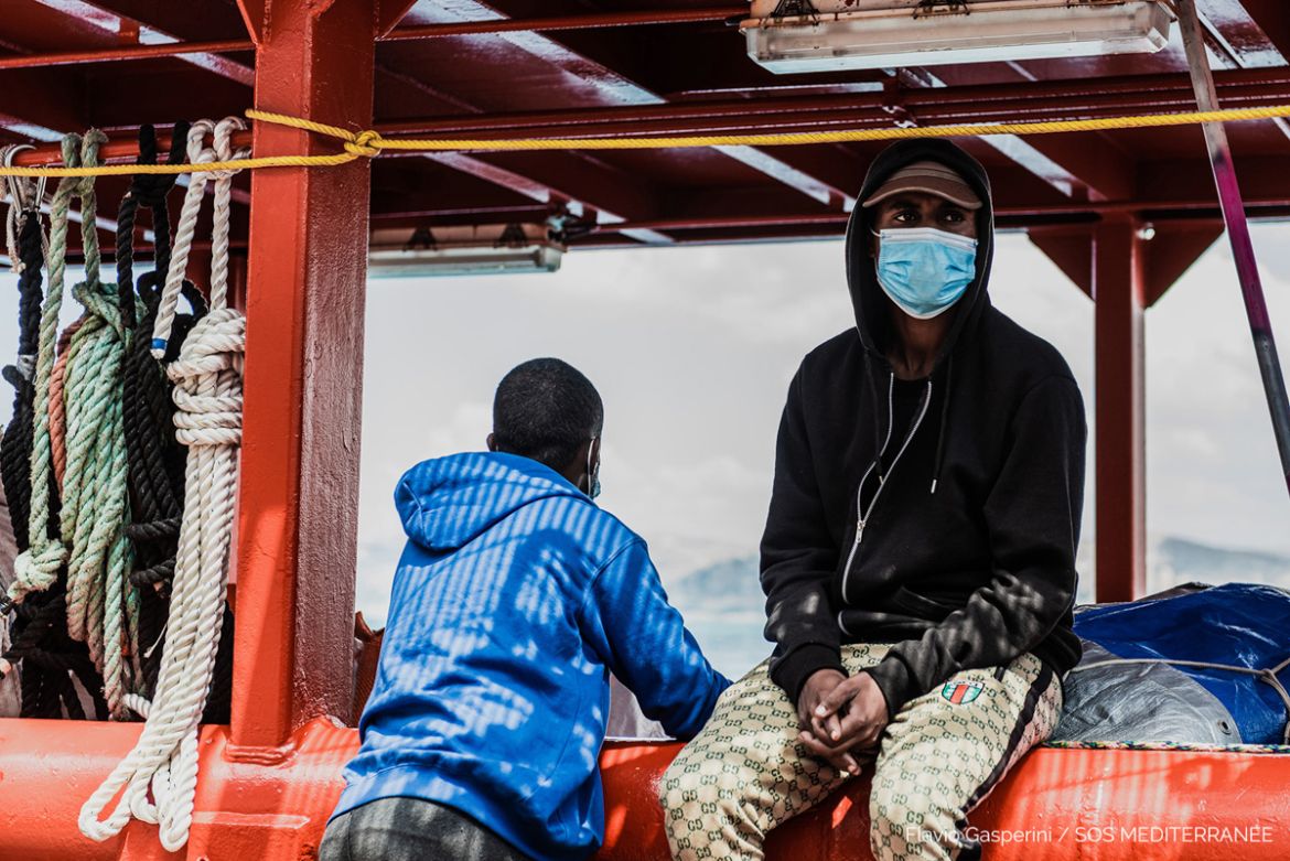 epa08530987 A handout photo made available by the press office of SOS Mediterranee, shows migrants on board the Ocean Viking ship anchored off the Sicilian port of Porto Empedocle in compliance with o