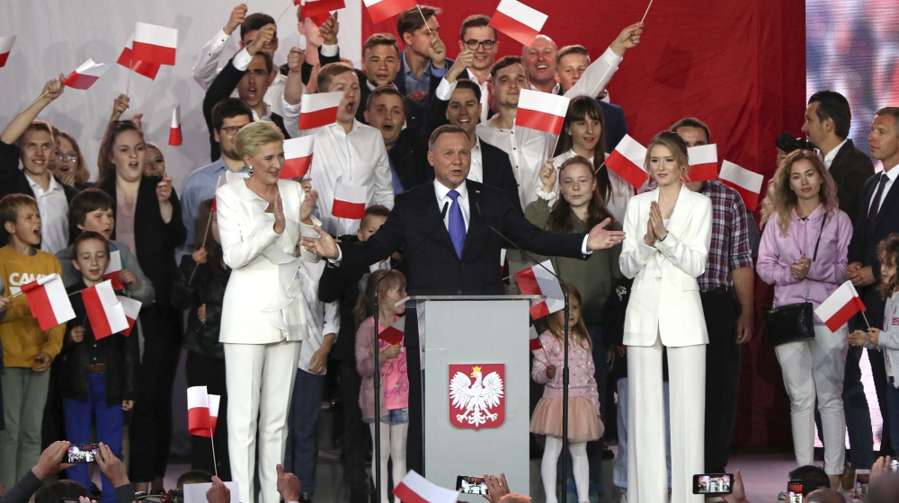 Incumbent President Andrzej Duda, center, gestures next to his wife Agata Kornhauser-Duda and daughter Kinga, right while speaking to supporters in Pultusk, Poland, Sunday, July 12, 2020. Conservative