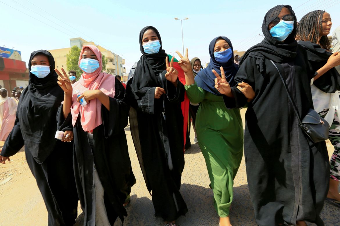 Civilians chant slogans as members of Sudanese pro-democracy protest on the anniversary of a major anti-military protest, as groups loyal to toppled leader Omar al-Bashir plan rival demonstrations in