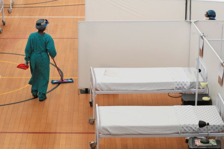 A health worker walks between beds at a temporary field hospital set up by Medecins Sans Frontieres (MSF) during the coronavirus disease (COVID-19) outbreak in Khayelitsha township near Cape Town