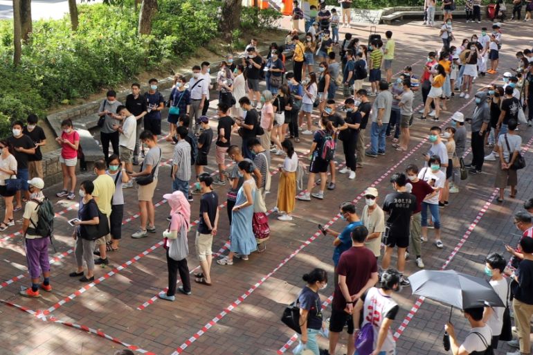 Voters queue up to vote during primary elections aimed for selecting democracy candidates, in Hong Kong