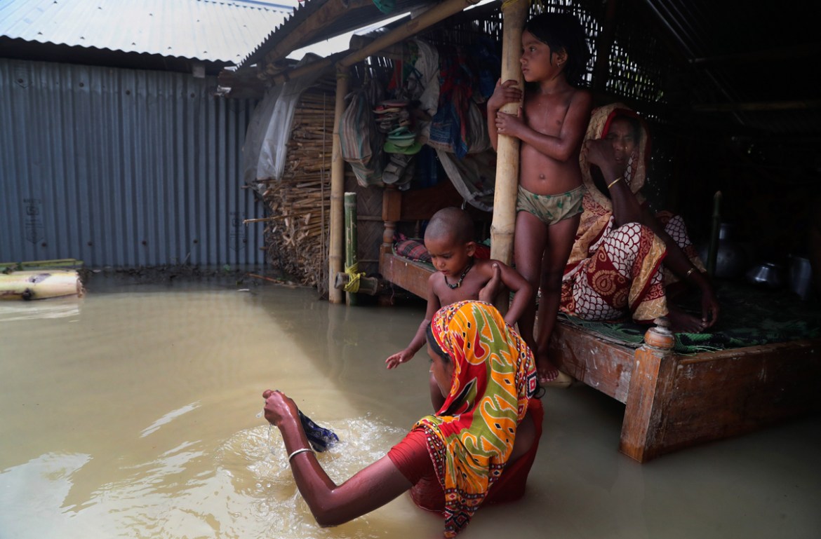 Indian flood affected villagers are seen inside their partially submerged houses in Gagolmari village, Morigaon district, Assam, India, Tuesday, July 14, 2020. Hundreds of thousands of people have bee