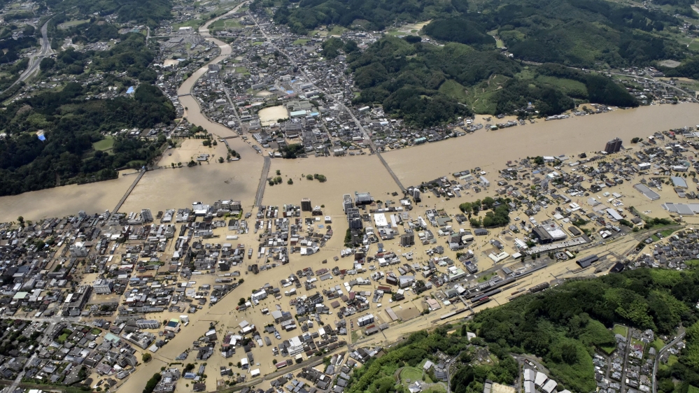 An aerial view shows flooded Kuma River caused by heavy rain at a residential area in Hitoyoshi, Japan