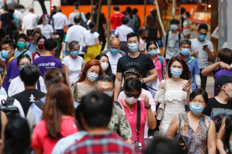 People wear surgical masks following the coronavirus disease (COVID-19) outbreak in Hong Kong