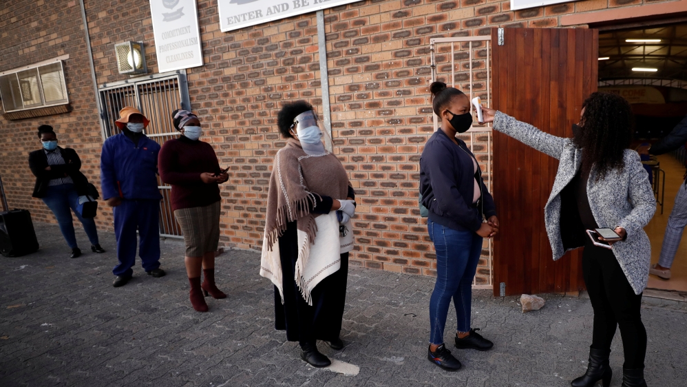 Teachers practice social distancing before being screened after the coronavirus disease (COVID-19) lockdown in Cape Town