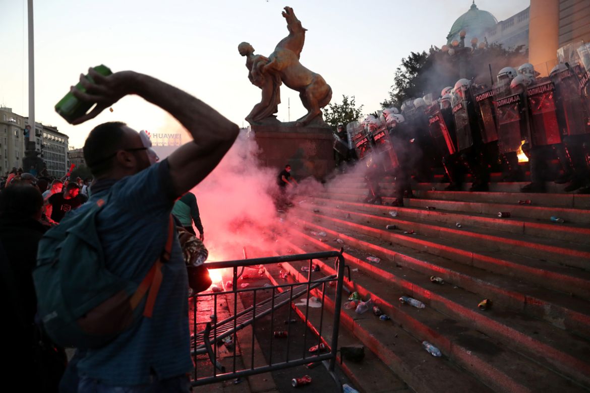 Demonstrators clash with police officers during an anti-government rally, amid the spread of the coronavirus disease (COVID-19), in front of the parliament building in Belgrade, Serbia, July 8, 2020.