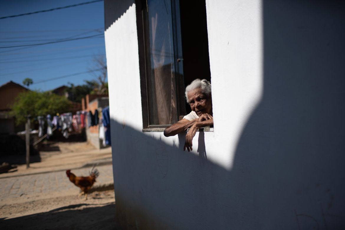 Eva Maria de Jesus, affectionately known as "Avo Eva" or Grandmother Eva, 110, looks from her home''s window in the Rasa "Quilombo," comprised of people descended from runaway slaves, in Buzios, Brazil
