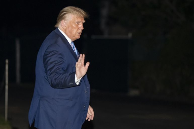 President Donald Trump waves as he walks from Marine One as he returns to the White House from Texas, Wednesday, July 29, 2020, in Washington. (AP Photo/Alex Brandon)