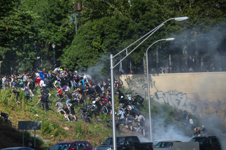 PHILADELPHIA, PA - JUNE 01: protesters race up a hill after being shot by tear gas after a march through Center City on June 1, 2020 in Philadelphia, Pennsylvania. Demonstrations have erupted all acro